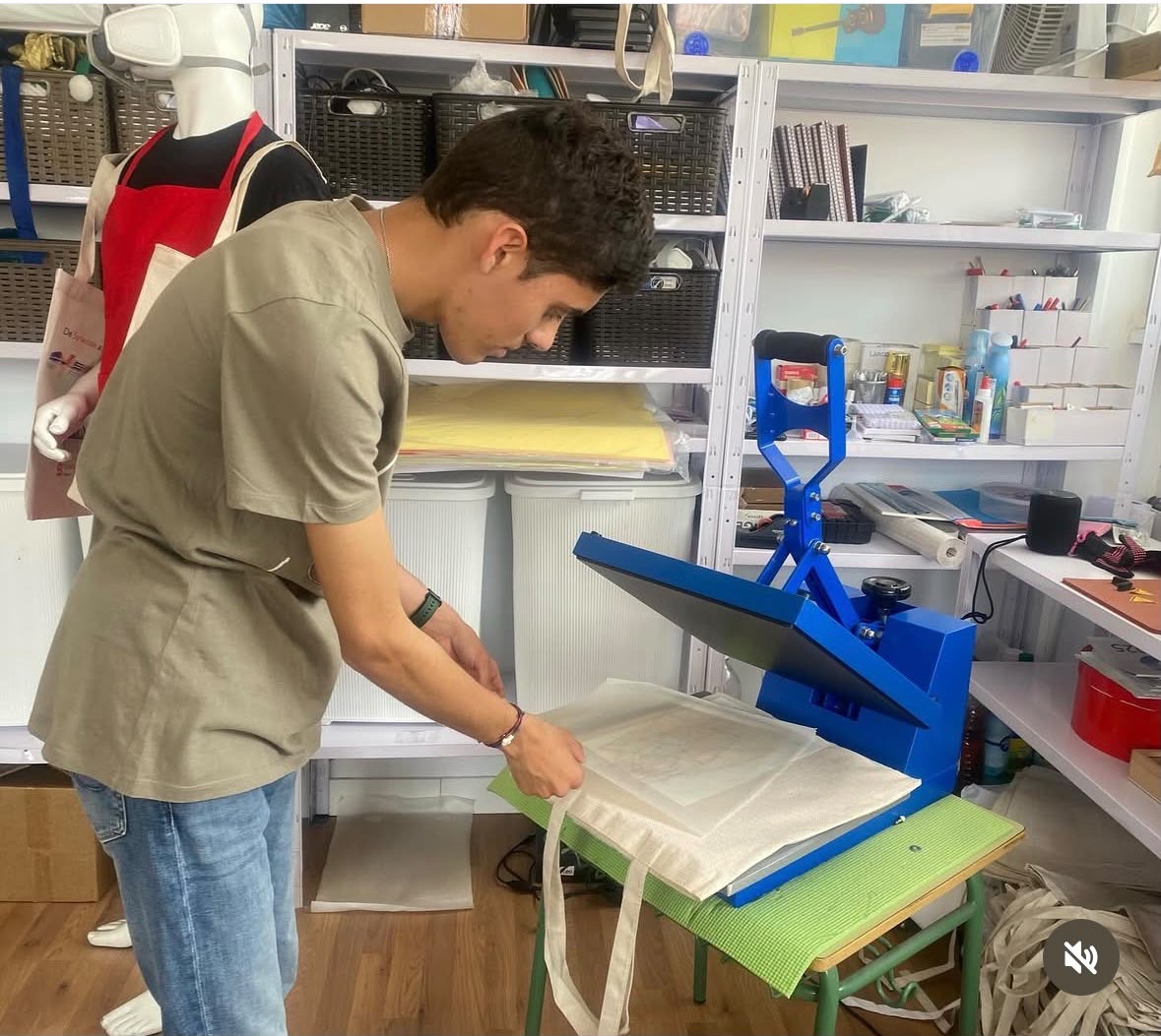 TAO student preparing a tote bag for printing