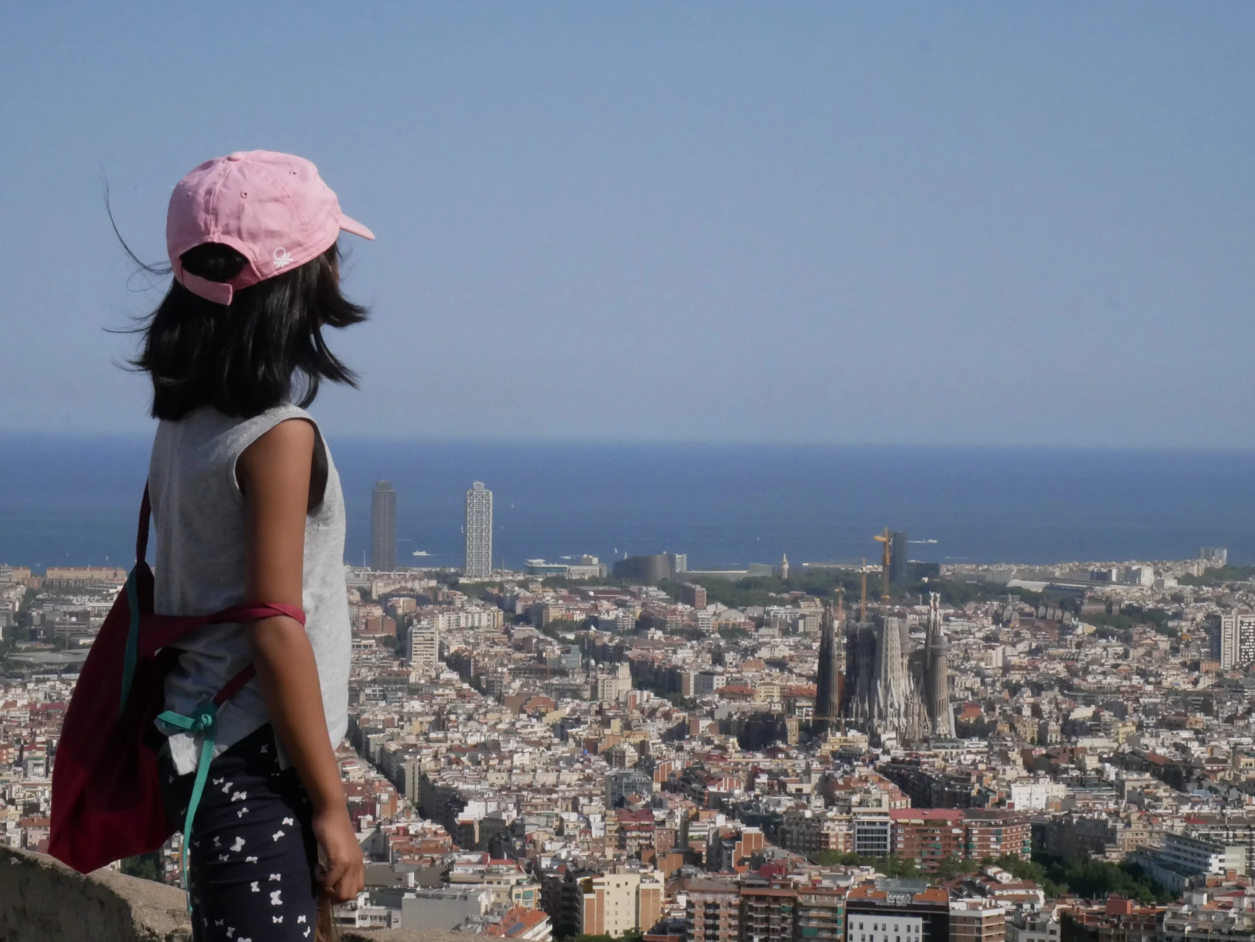 A child looking out over Barcelona from a viewpoint